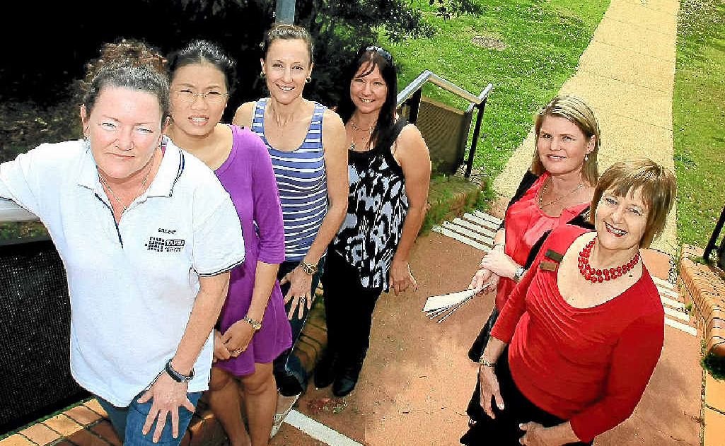 Michelle Caton, Chanthale Koukeomanivong, Lisa Cefai and Tina Hoovin receive their scholarships from Julie Board and Jan Ingwersen.